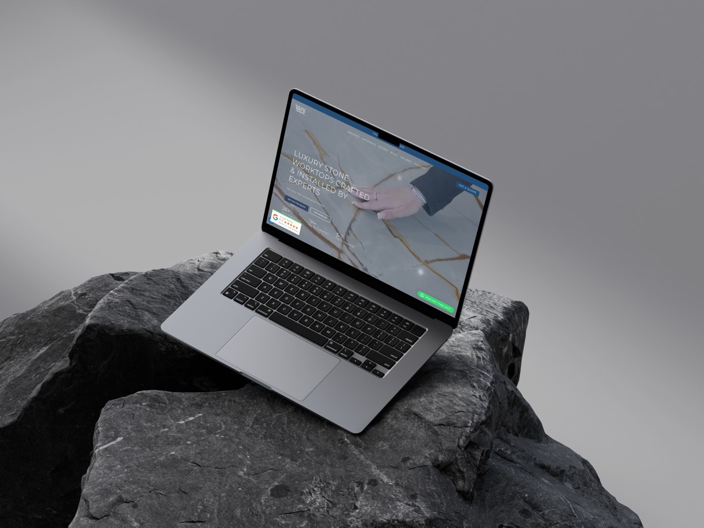 The Only Way Is Granite website shown on a laptop resting on dark stone